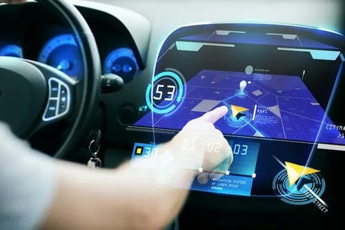 A driver interacting with a futuristic in-car touchscreen displaying a map and speed readout.