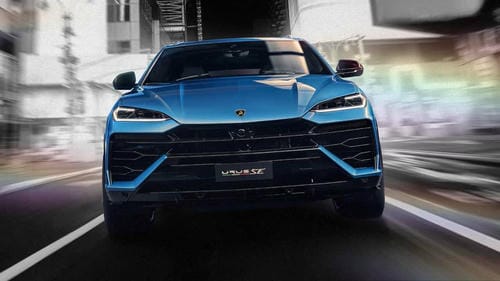 A blue Lamborghini Urus SUV speeding down a city road.
